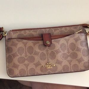 Coach pouch crossbody bag with removable slim wallet.